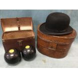 An oval Victorian scumbled tin hatbox with hinged lid containing a bowler hat by The Comfort Hat Co;