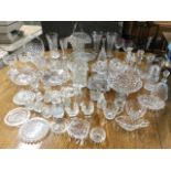 A quantity of glass including vases, bells, pairs of candlesticks, large basket vases with