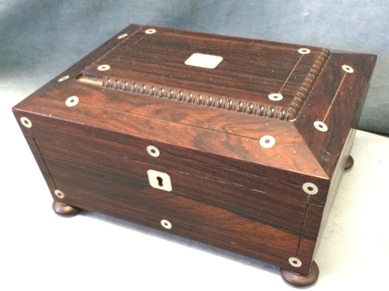 A Victorian rosewood sewing box with bead framed tablet to hinged lid, inlaid with mother-of-pearl