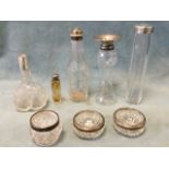 Three cut glass basin salts with hallmarked silver mounts; a cut glass vase with hallmarked silver