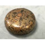 A bun shaped eastern bowl & cover with floral decoration on gilt scrolled ebonised ground -