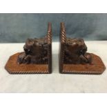 A pair of Victorian carved oak book-ends with pawed lions as supports for brackets, with ropetwist