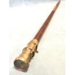 A contemporary tapering hardwood walking cane with brass mounts, having compass under glass to
