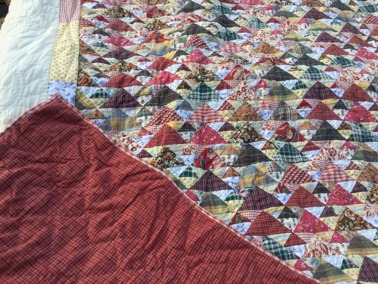 A pair of cotton quilts, the central panels with multi patterned triangles framed by a border of - Image 3 of 3