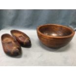 An ancient turned hardwood bowl; and a pair of original carved Dutch clogs with painted