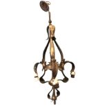 An art nouveau hammered brass hanging light with tubular column hung from ceiling rose having