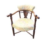 A Victorian rosewood boxwood strung armchair, with upholstered back above a ribbon inlaid splat, the