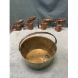 A Victorian brass jam pan with riveted overhanging iron handle; and four copper blow lamps. (5)