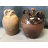 An antique stoneware salt glazed ovoid oil pot with applied twin handles and spout to side; and