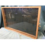 A glazed pine wall-mounting display case or notice board with hinged lid, complete with brass