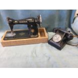 A Singer electric cast iron sewing machine, mounted on later drawer stand; and an old black bakelite