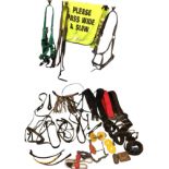 A box of horse tack - leather belts, bridles, stirrups, girths, nosebands, bits, etc. (A lot)