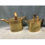 A Victorian brass Merridale watering can of rectangular rounded form having ebony ribbed handles;