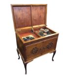 An Edwardian mahogany cased wind-up gramophone with moulded caddy top enclosing the working