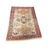A silk & cotton Turkish rug, the ivory field woven with birds, animals and star motifs around a