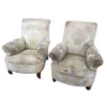 A pair of 1950s upholstered armchairs with high backs and flared arms above sprung upholstered