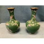 A pair of Chinese cloisonné vases decorated with greek key style wirework and floral bands on