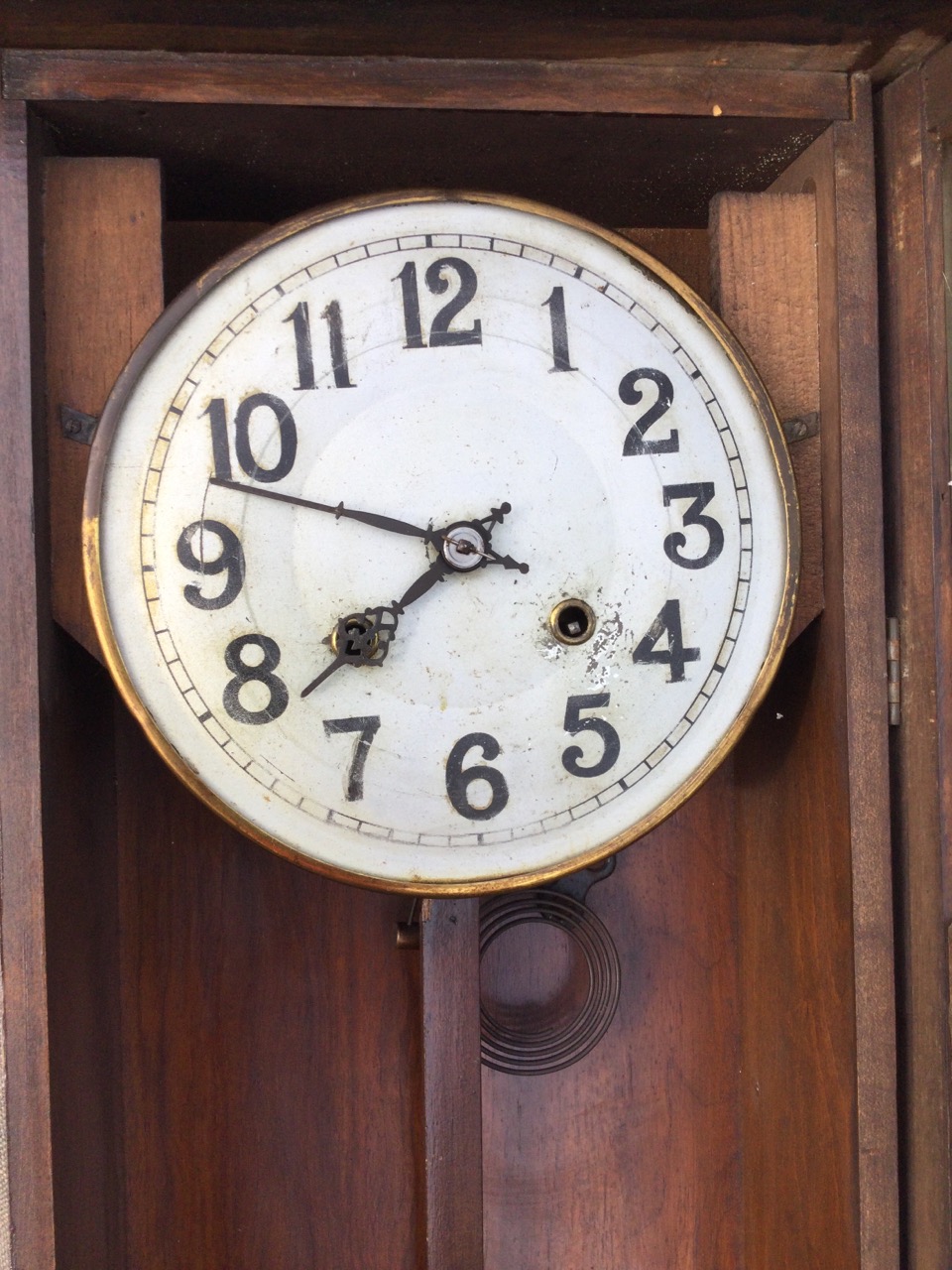 A stained Vienna wallclock with broken pediment framing a turned finial, above an arched door - Image 2 of 3