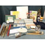 A quantity of artists materials including brushes, paints, sketch pads, painting sets, canvases,