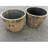 A pair of oak garden tubs - cut from barrels, the staves each bound by riveted metal strap bands. (