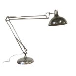 A chromed giant anglepoise style light with bowl shaped shade on sprung arms, above a circular