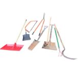 Miscellaneous garden tools including a snow shovel, a log saw, a scythe, a ditching spade, a hoe,