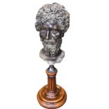 A contemporary bronze Zeus, the bearded head on fluted mahogany column stand with circular moulded