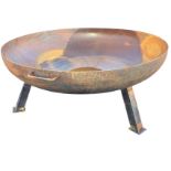 A wrought iron firepit bowl with two handles, raised on three square angled legs. (39.5in dia x