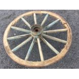 An old elm cartwheel with shaped oval spokes and metal hub, having flat forged rim. (32in dia)