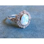 A boxed belle epoch style sterling silver opal ring, bezel set with a rectangular rounded stone