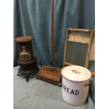A pine framed glass washboard; a circular enamelled tin bread bin & cover; a Valour tubular paraffin