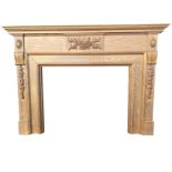 An oak chimneypiece with moulded mantelpiece above a frieze with applied carved floral panel, the