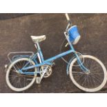 A 1970s ladies Raleigh 18 denim bicycle with mudguards, basket pannier, three speed Sturmy Archer