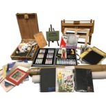 Miscellaneous artists sketchbooks, paper pads, tracing paper, two paint boxes with paints, easels,