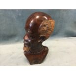 A heavy carved African hardwood bust, the head with bead necklace looking to dexter. (10in)