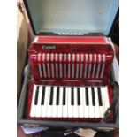 A cased German piano accordion with Bell retail label, the instrument with two octave keyboard