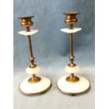 A pair of late nineteenth century gilt metal and alabaster candlesticks, the urn shaped