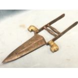 An Indian katar with tapering tooth shaped blade on iron handle with twin bar grips, the shoulders