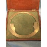 A mahogany cased surveyors brass circle with calibration to angled sharp rim. (10in dia)