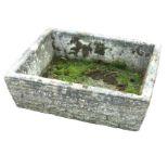 A rectangular composition stone trough with angled faux-brick cast sides. (25.5in x 20in x 8in)
