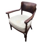 A Fischel bentwood elbow chair with curved back panel and shaped arms on bobbin turned columns,