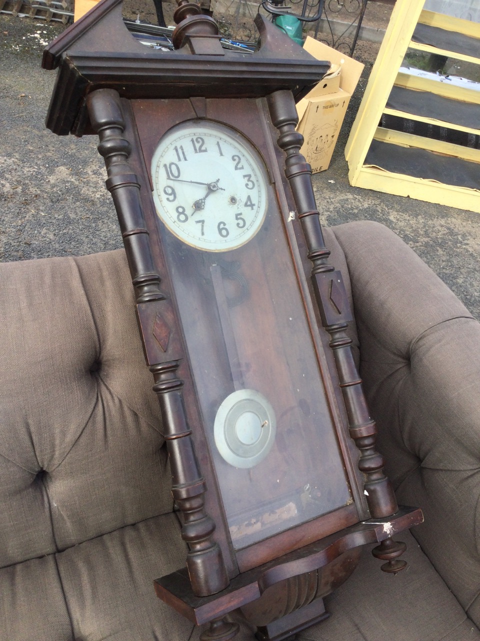 A stained Vienna wallclock with broken pediment framing a turned finial, above an arched door - Image 3 of 3