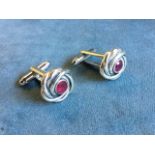 A boxed pair of sterling silver cufflinks in the form of celtic style entwined knots centred by