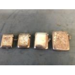 Four hallmarked silver rectangular vestas - plain, foliate engraved, rings to sides, all with