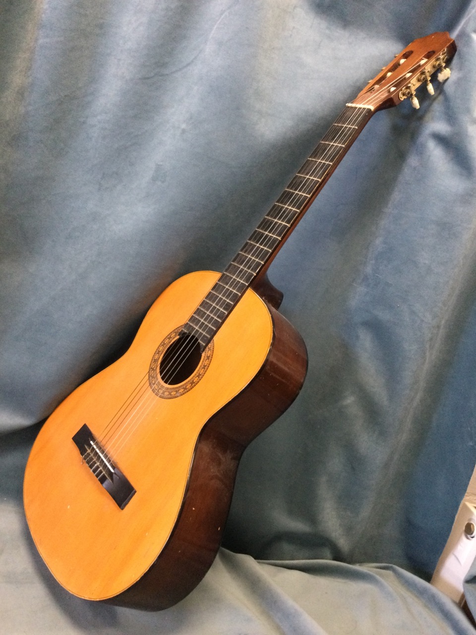 A Leonora classical nylon string guitar with cedar body, the soundhole with transfer decoration. (