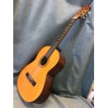 A Leonora classical nylon string guitar with cedar body, the soundhole with transfer decoration. (