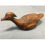 A North American carved bird with inlaid glass eyes and hooked beak - marked Nova Scotia under. (