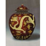 A contemporary silkwork picture of an oriental vase & cover, sewn with dragon and symbols on red