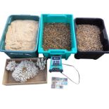 A box of coral sand for use in a marine aquarium; two boxes of pea gravel for a freshwater