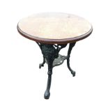 A circular cast iron britannia style table, the moulded top on three waisted beaded legs cast with